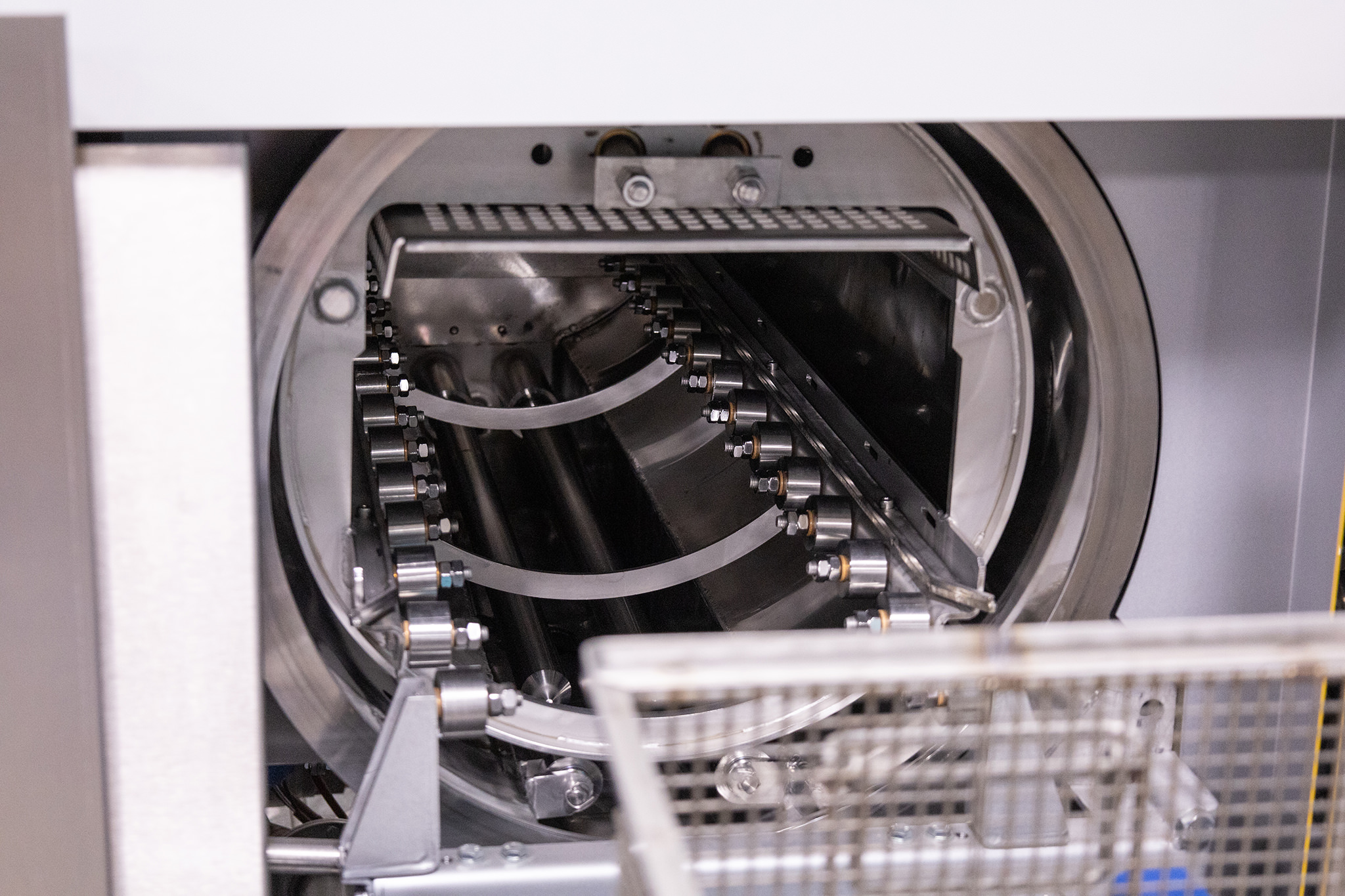 Parts in baskets entering the vacuum chamber